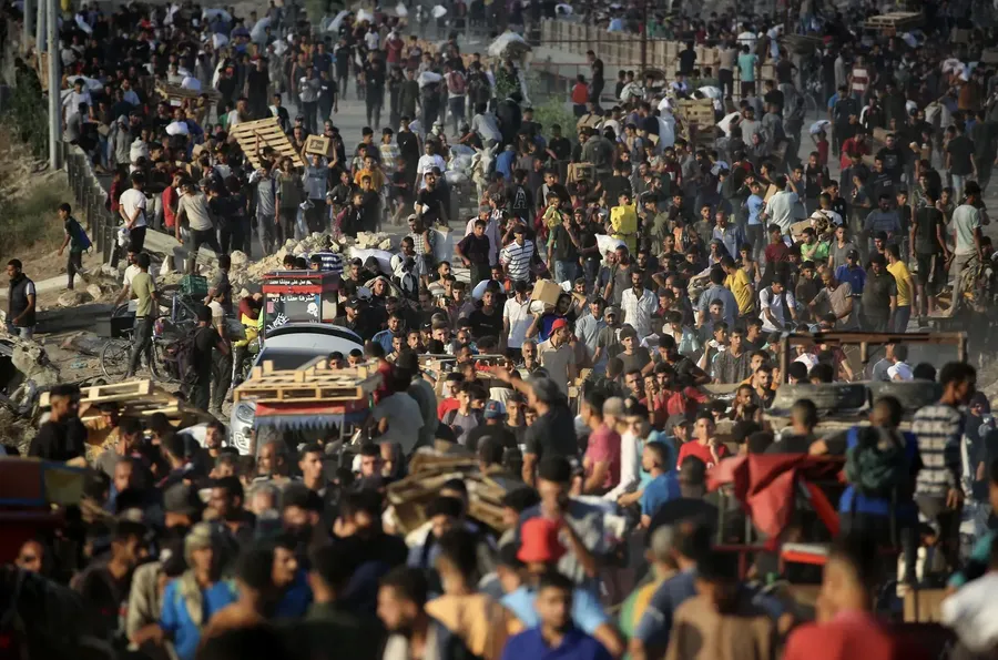 Palestinians gather at an aid distribution point